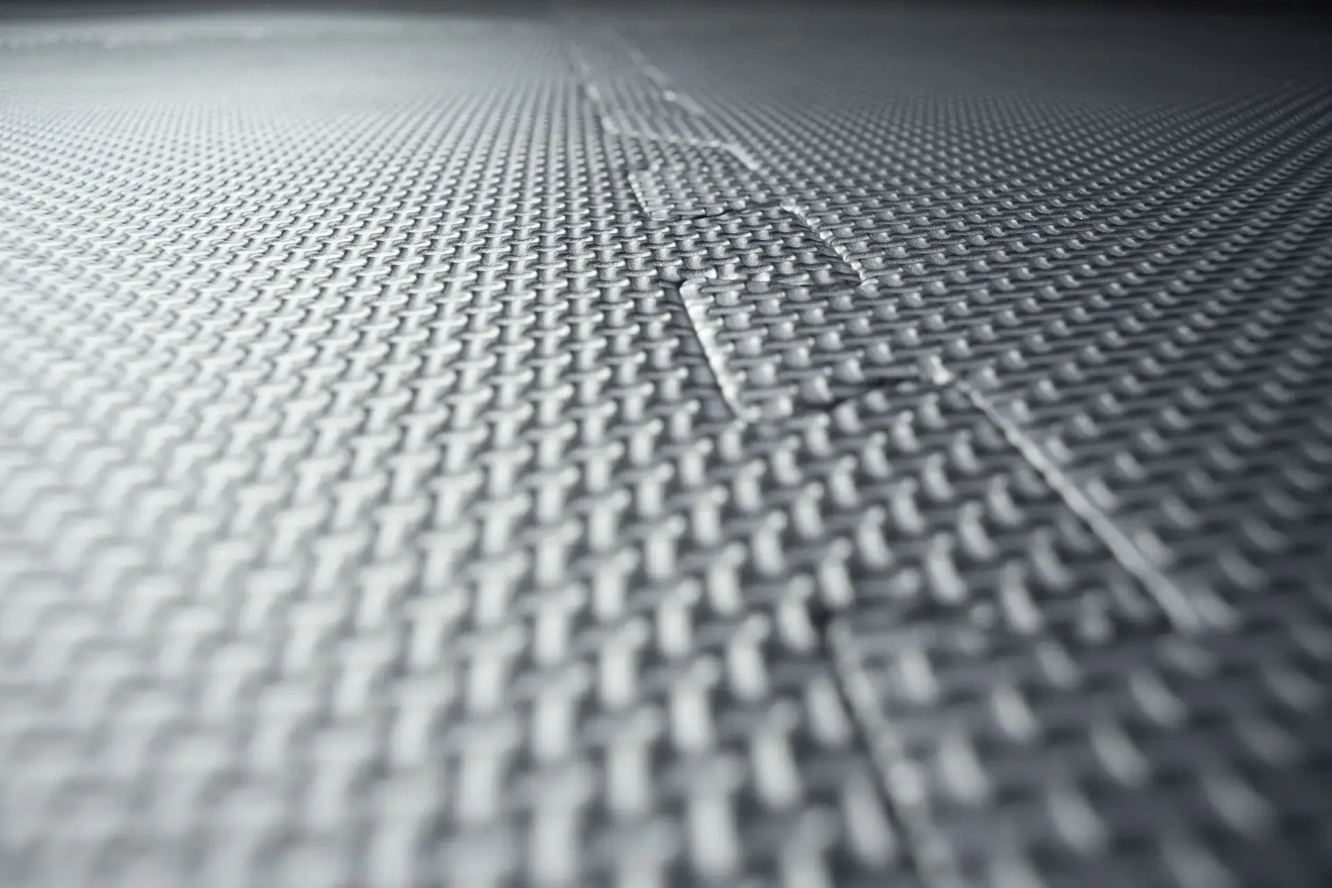 Close-up of interlocking floor mats with visible seam, symbolising integrated packaging and product design